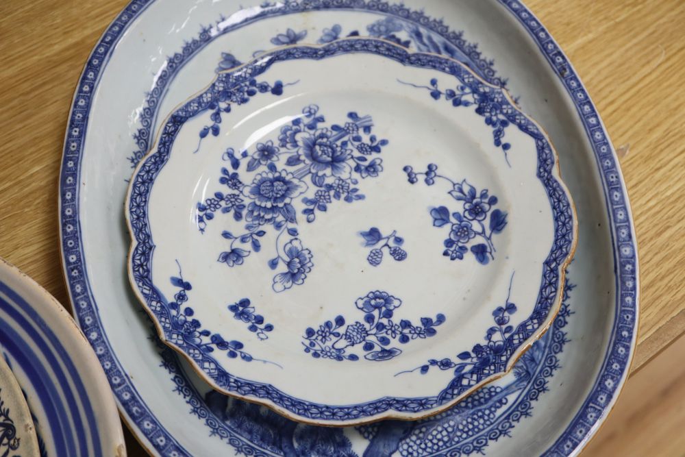An early 19th century Chinese floral plate, a Chinese blue and white plate and meat platter, together with two other dishes